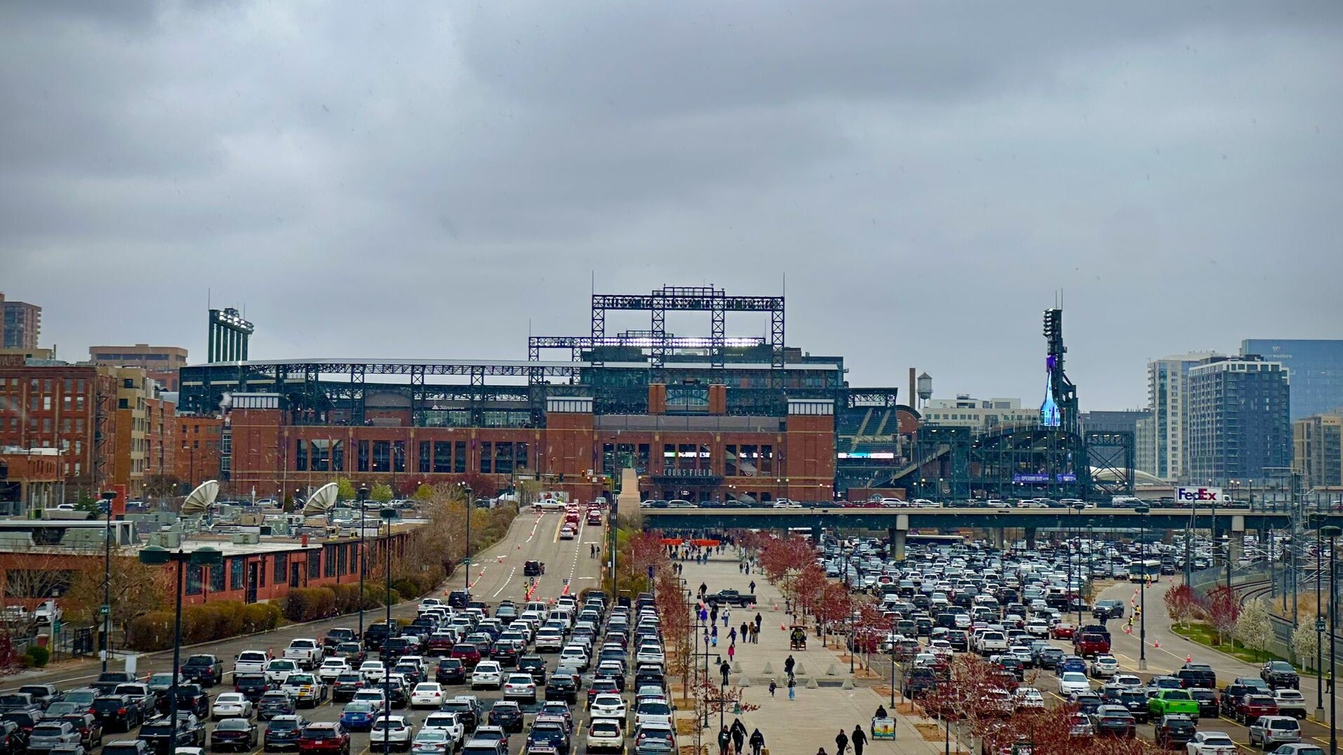 cars in a parking lot, view of stadium at the back