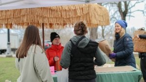 people talking in a farmers market