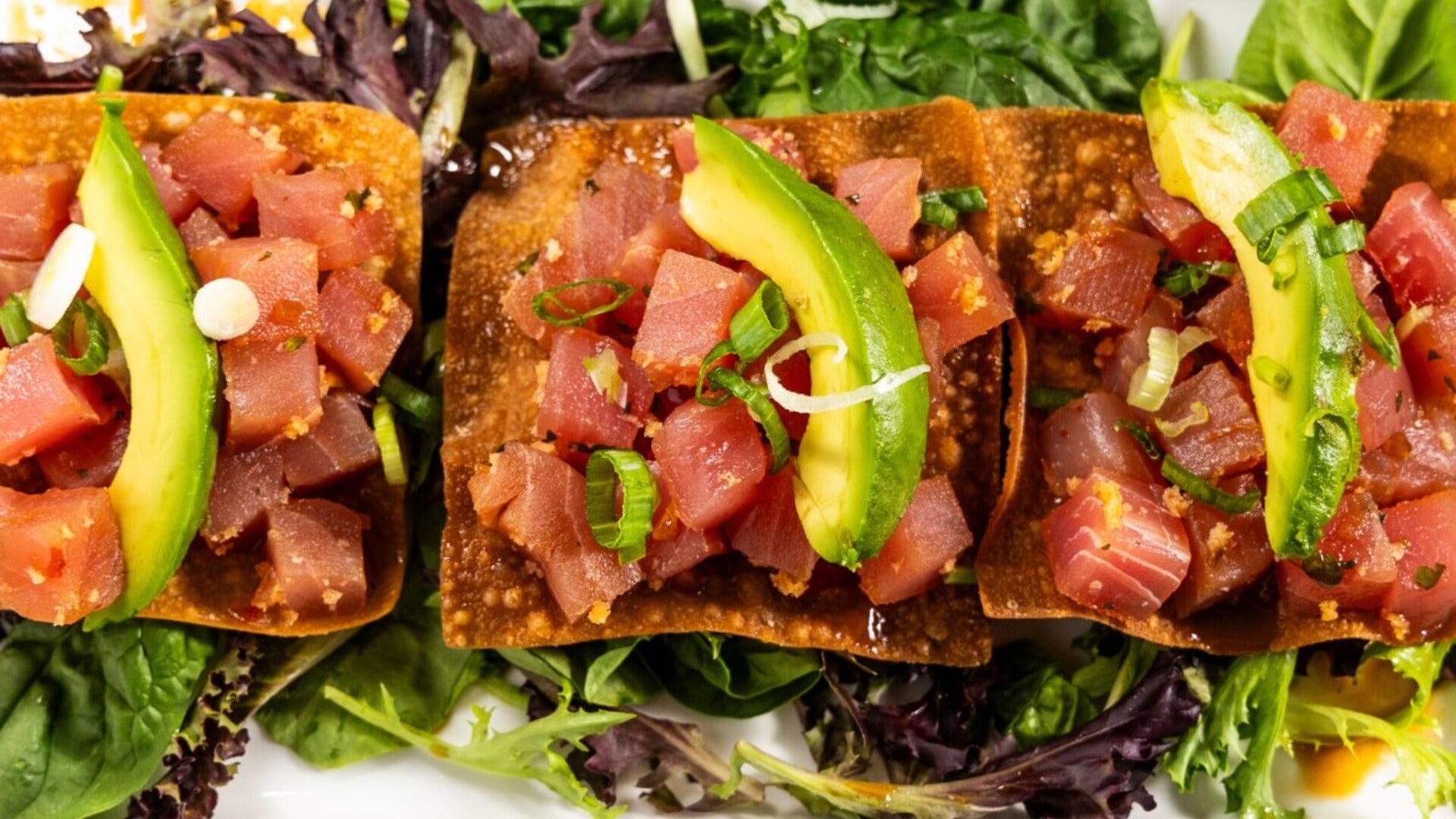 tuna tostada on a bed of vegetables