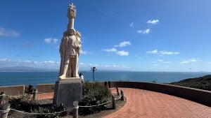 monument with a view of the sea and people watching it