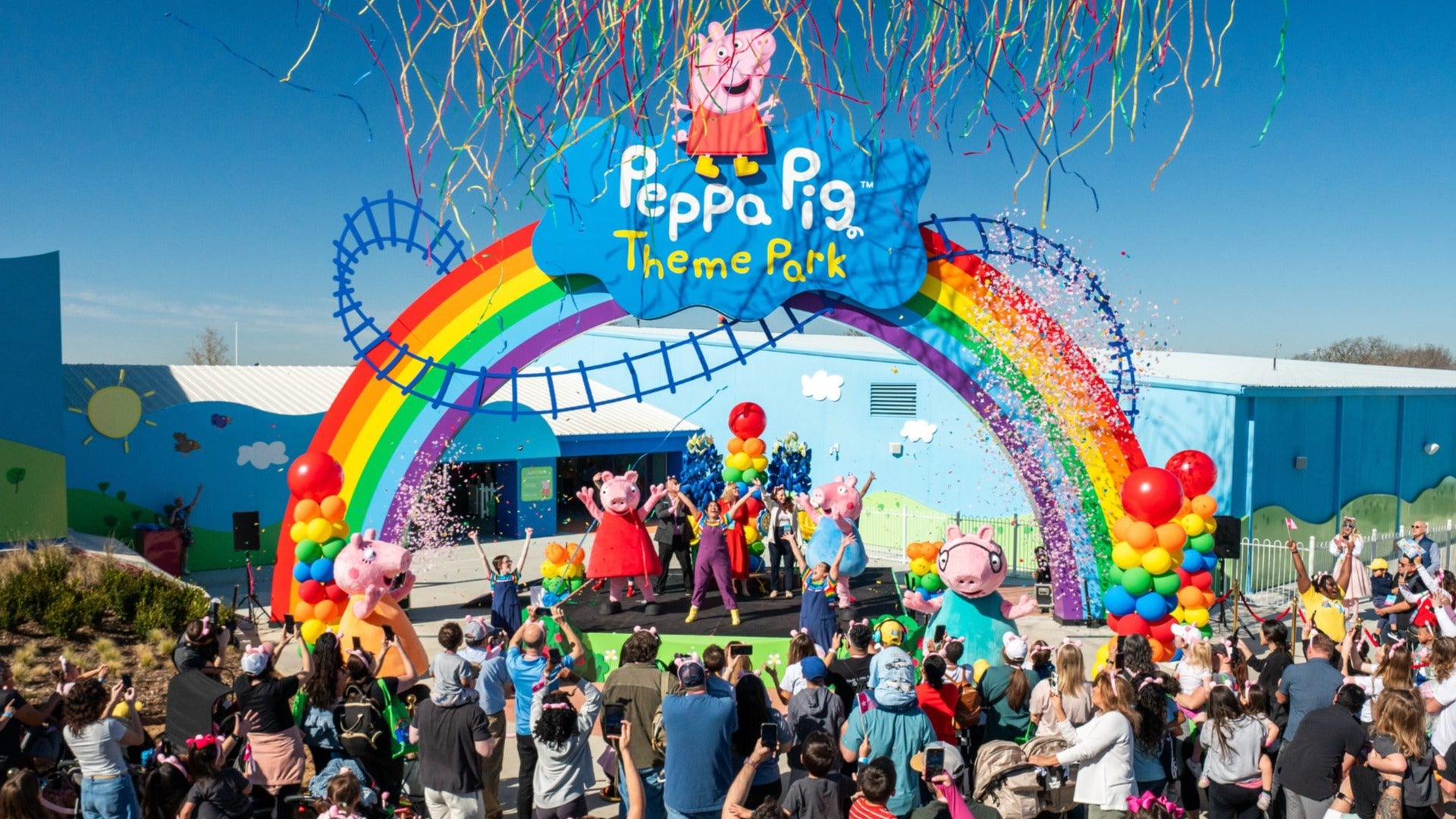 opening of a theme park with people celebrating on stage