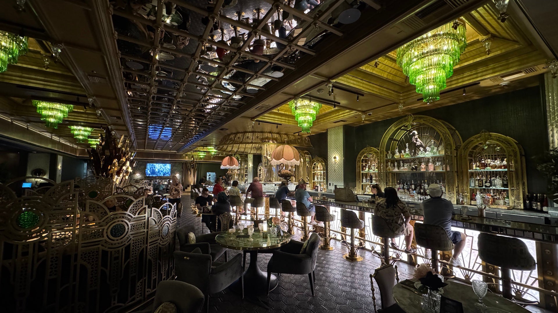 Glam bar with green chandeliers inside Pinky's by Vanderpump - Las Vegas, Nevada, USA