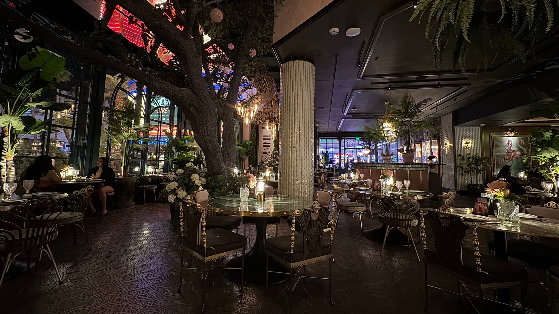 Interior of a glam restaurant and bar with velvet accents and greenery