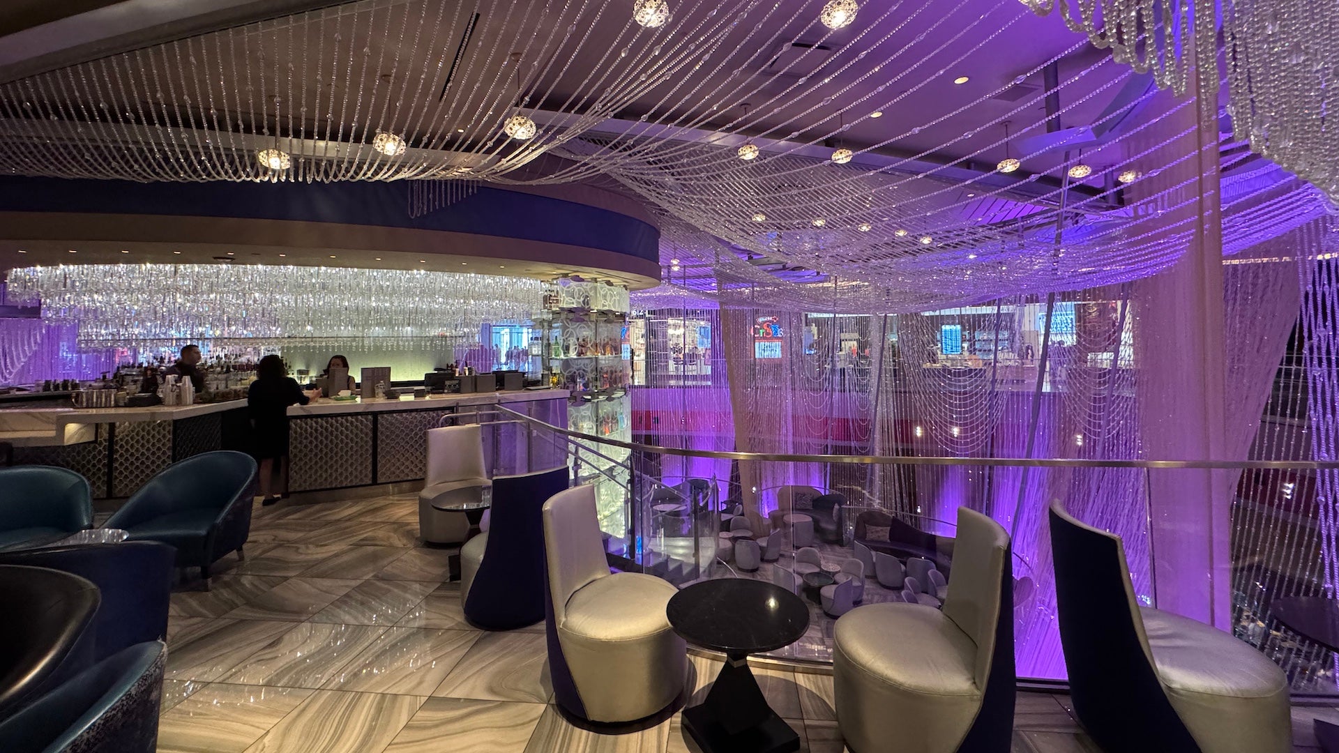 Chandeliers hanging from the ceiling on the bar's second level