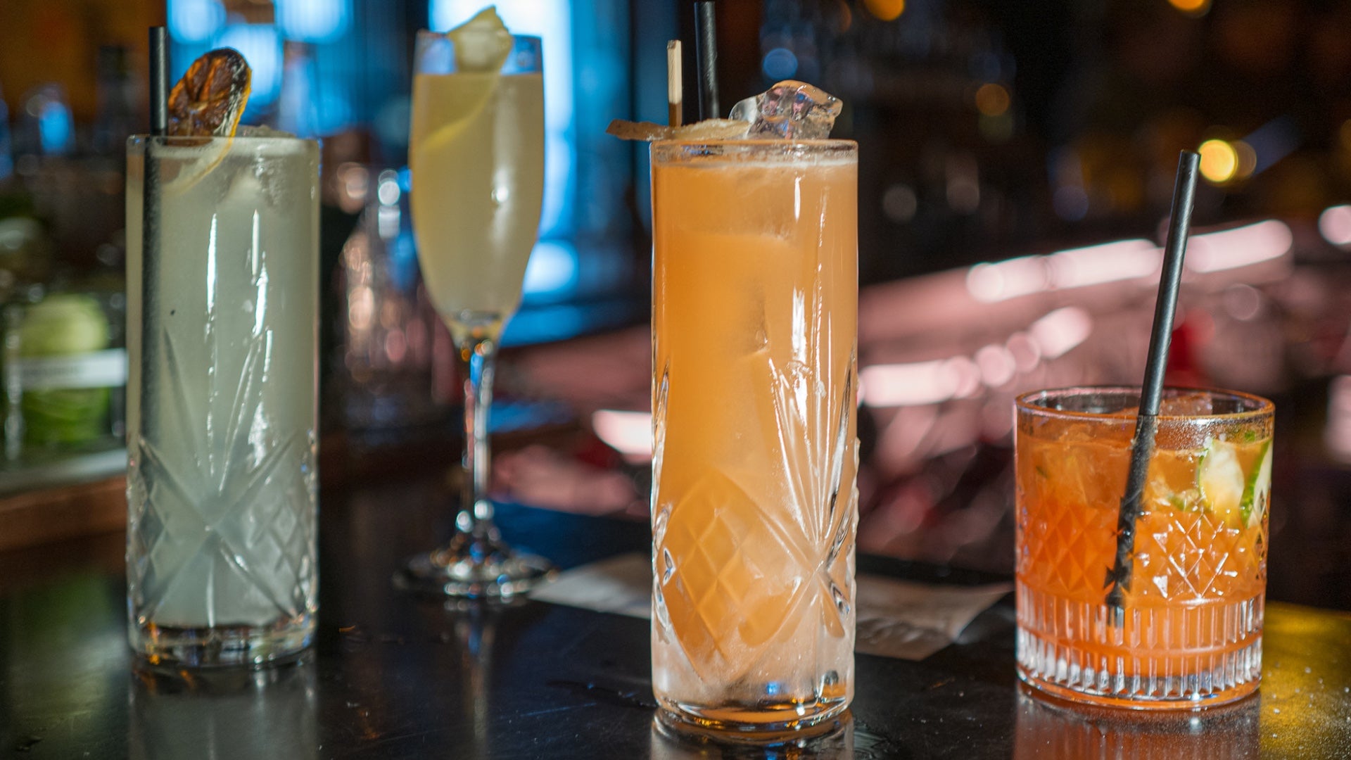 Four cocktails on a bar at a restaurant in san diego