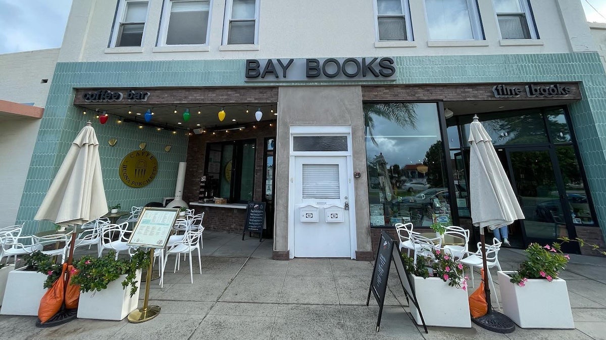 Exterior of a book store in Coronado California with tables and umbrellas