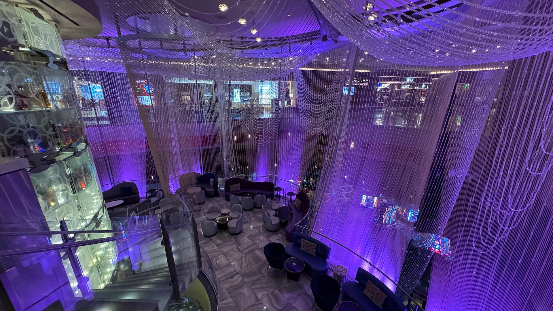 Chandeliers hanging from the ceiling on the bar's second level