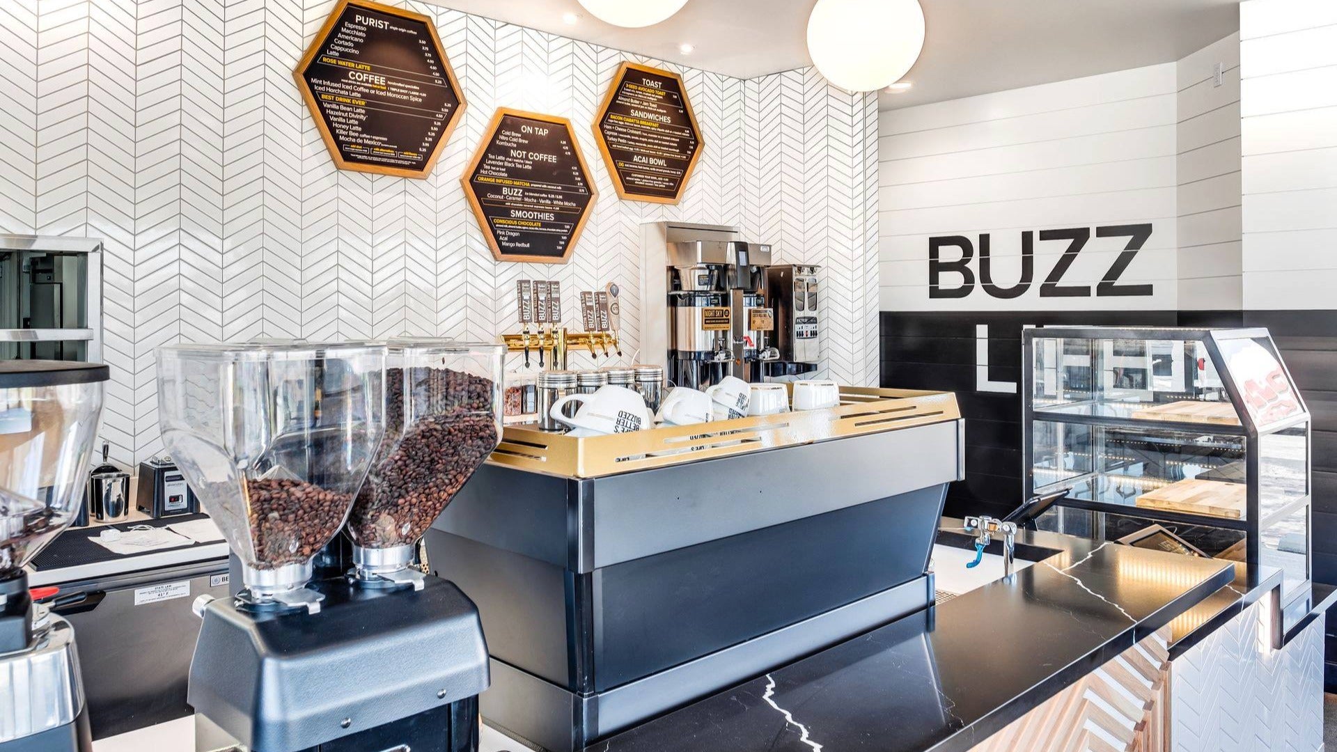 cafe counter with display of beans, cups and menu