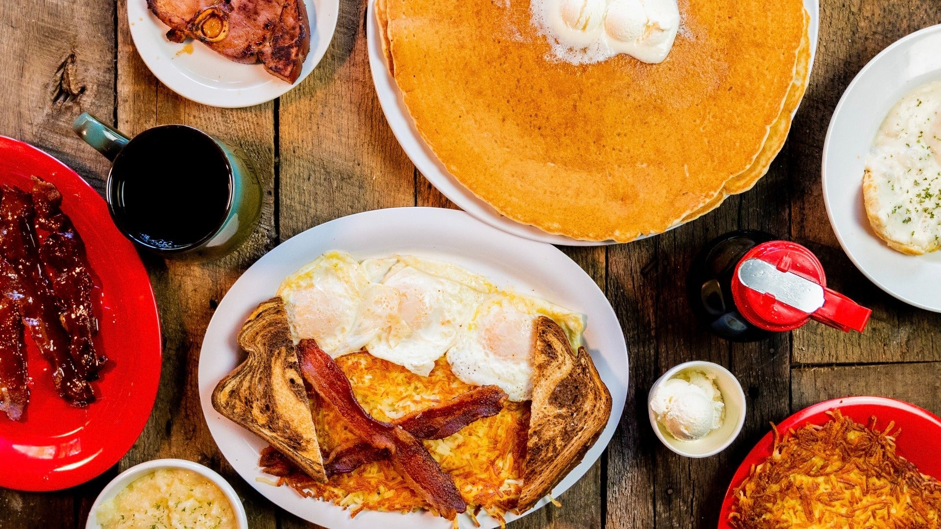 breakfast spread with pancakes, toast, eggs, coffee, and more