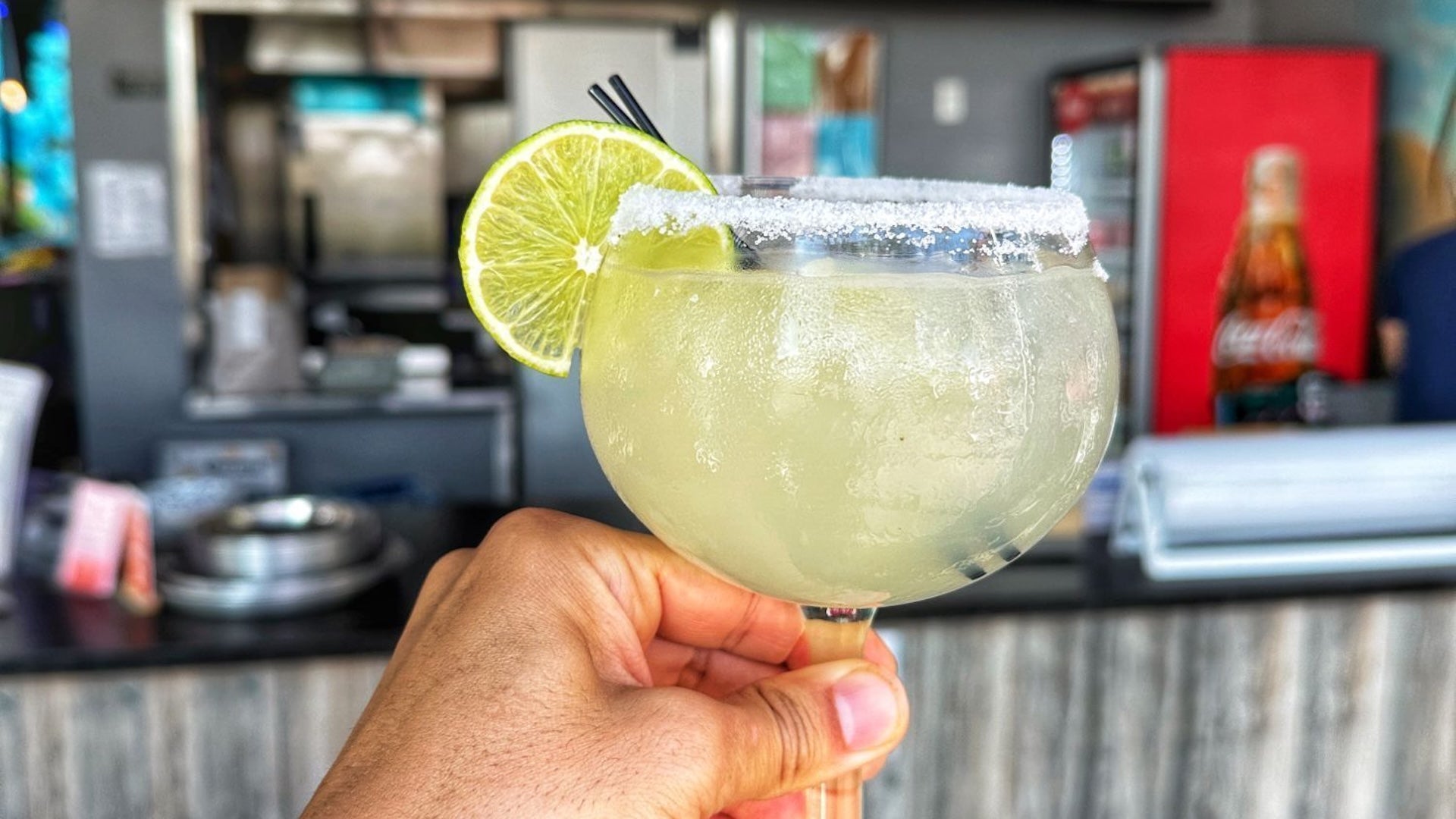 a glass of margarita with a slice of lemon