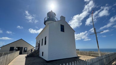 a side view of a lighthouse during a sunny day