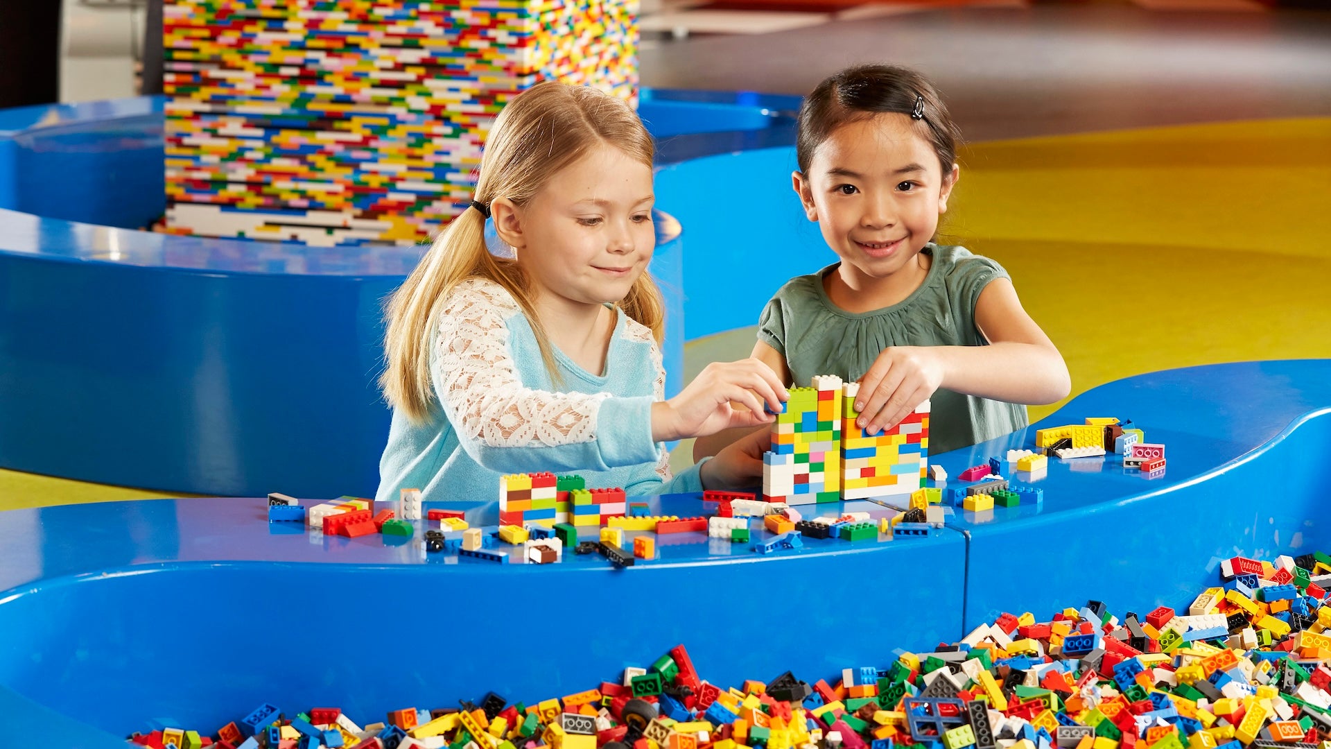 Two girls playing in a brick pit at legoland Chicago