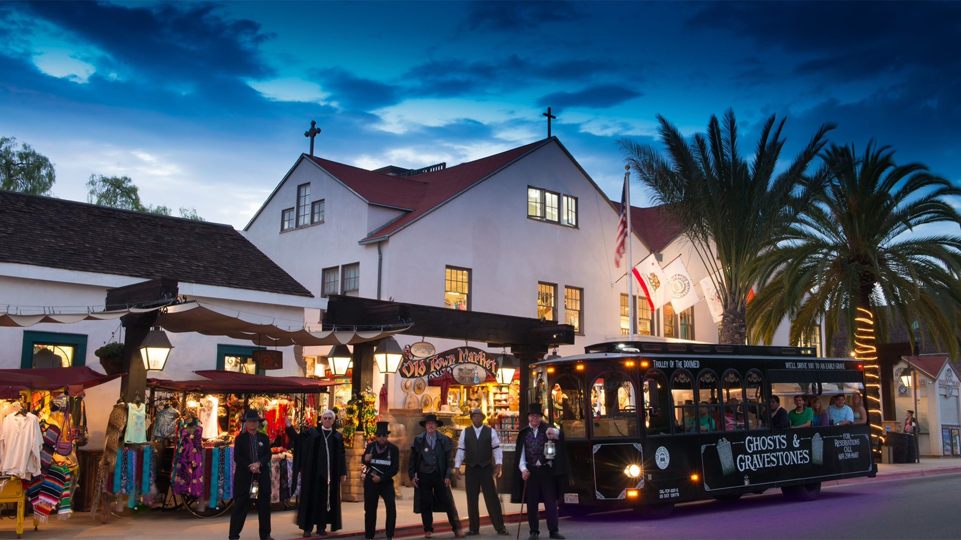 people in costumes and a trolley with passengers behind