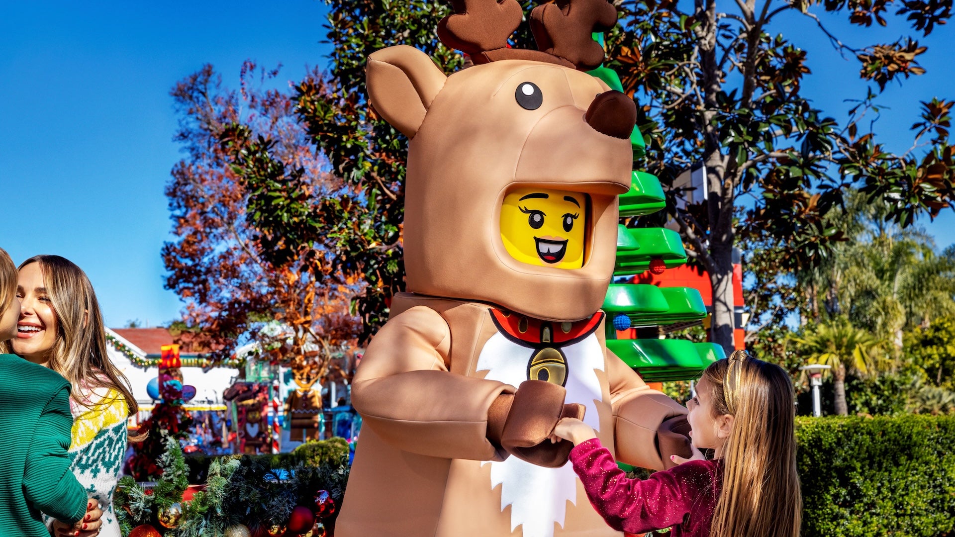 Lego reindeer character with a little girl at Holidays at legoland Florida