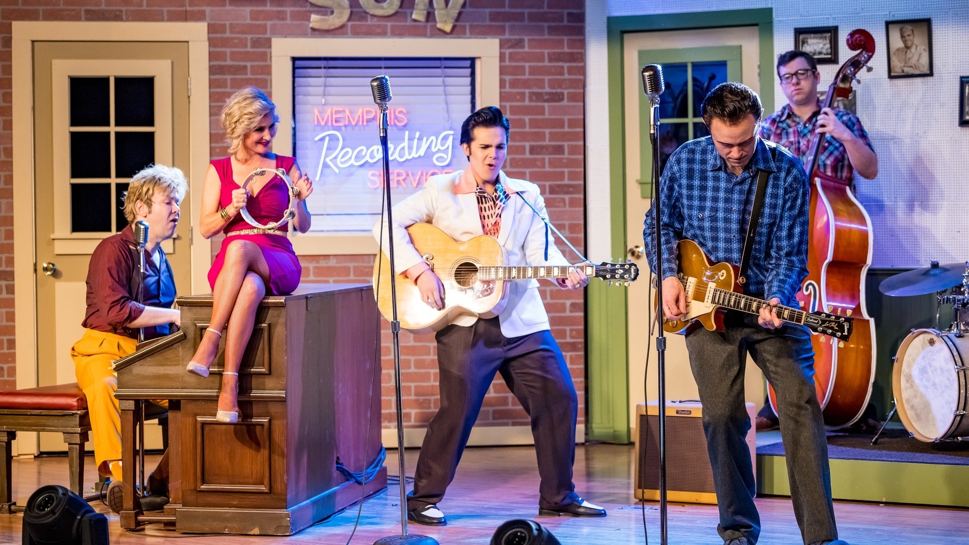 group of performers on stage with musical instruments