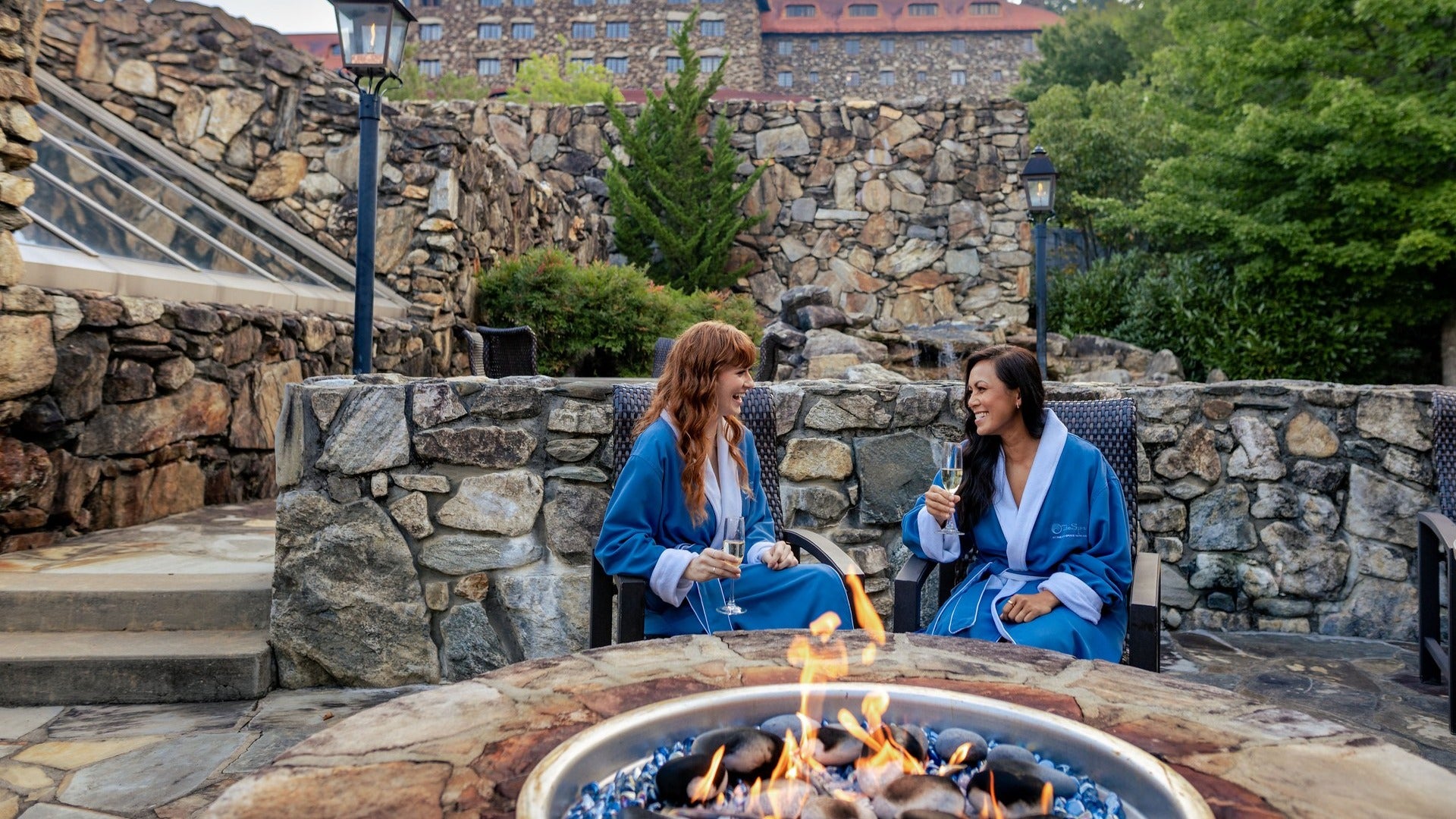 girls chatting in front of fire pit