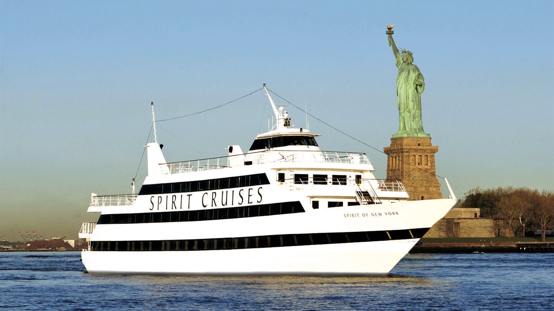 a boat sailing near the Statue of Liberty