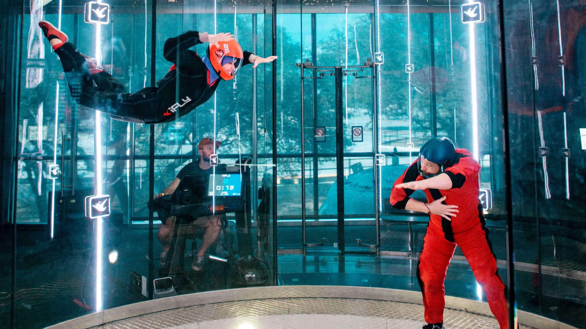 instructor and skydiver in an indoor facility