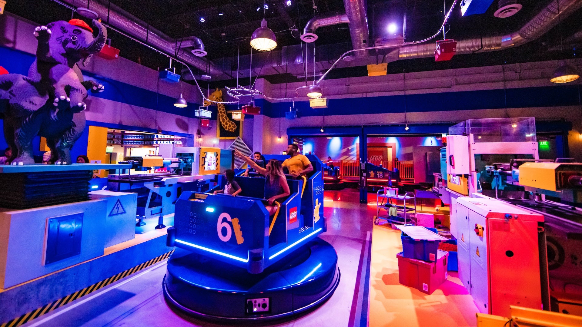 Families riding an indoor ride at LEGOLAND New York