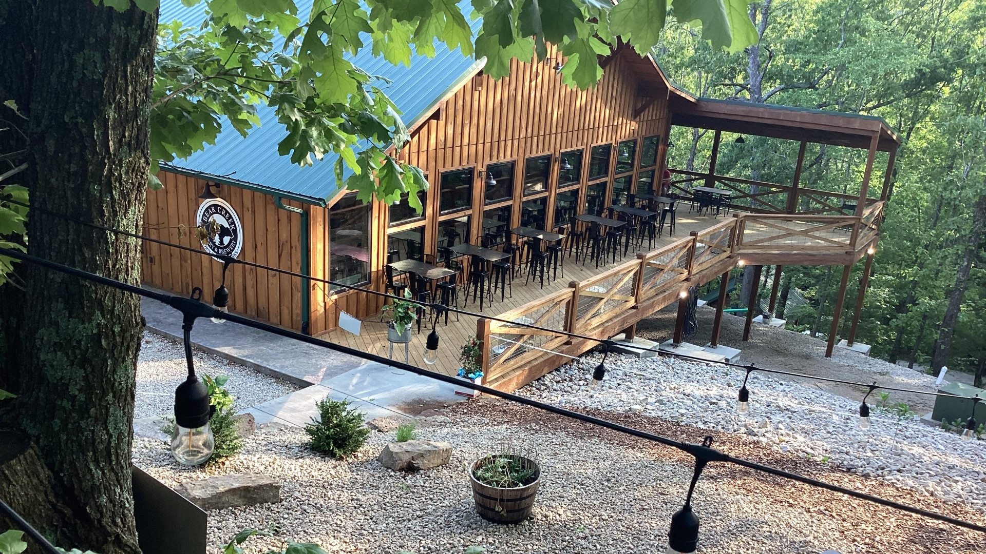 outdoor restaurant with lights and trees at the back
