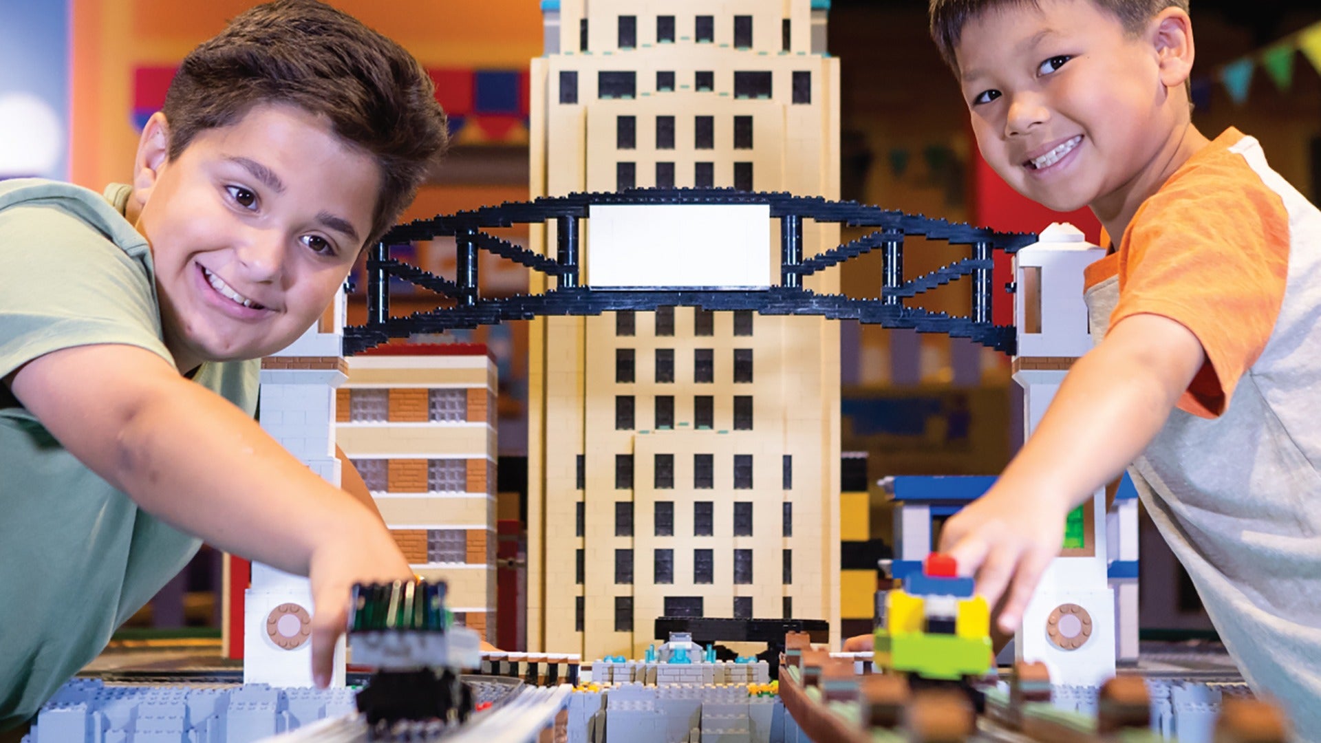 boys playing with a lego city