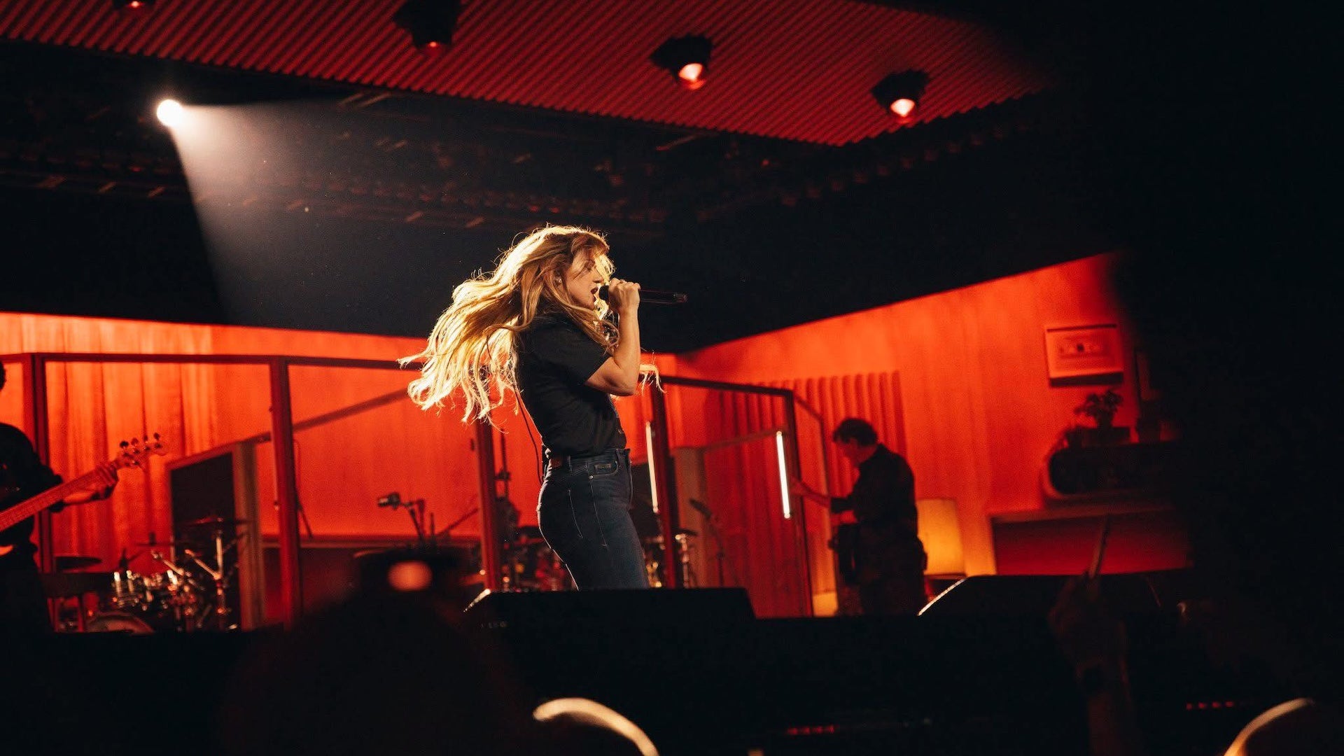 a woman singing at the stage
