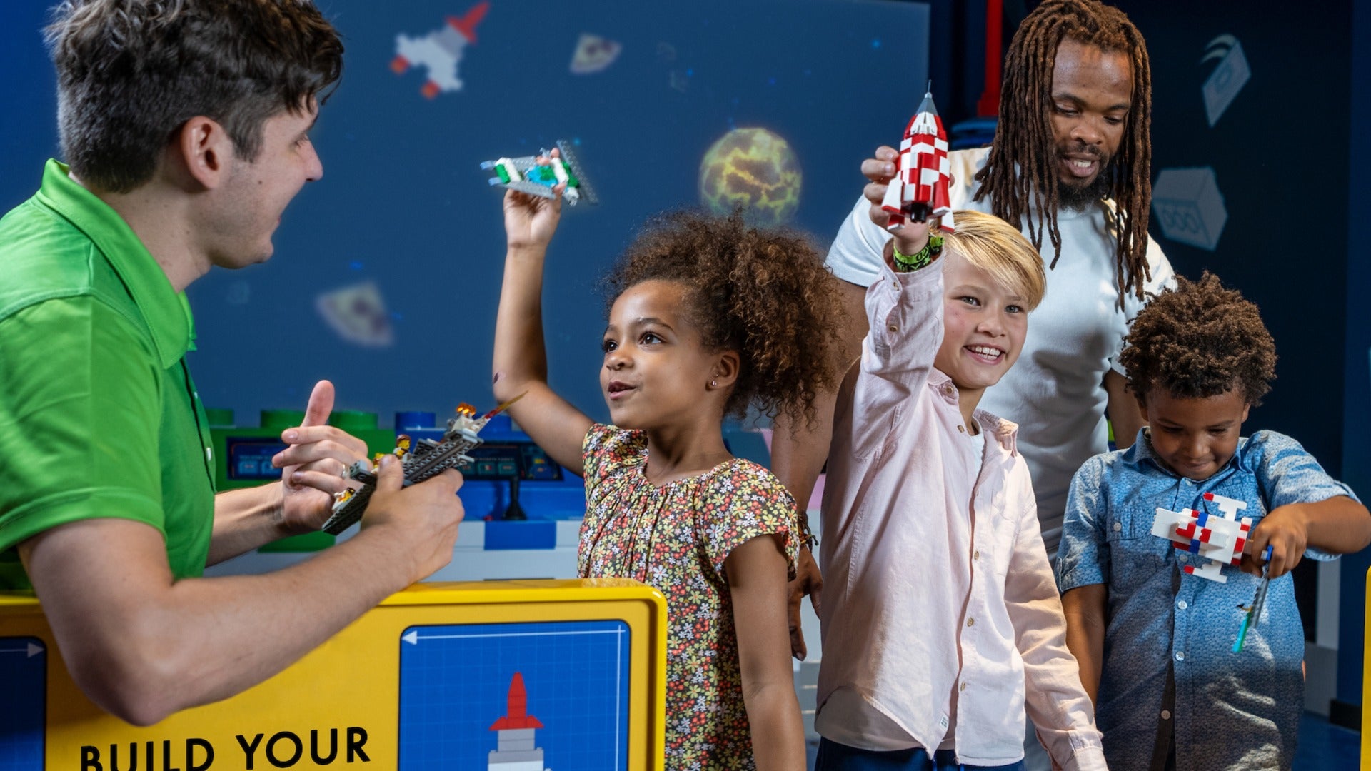 children playing with spaceships supervised by adults