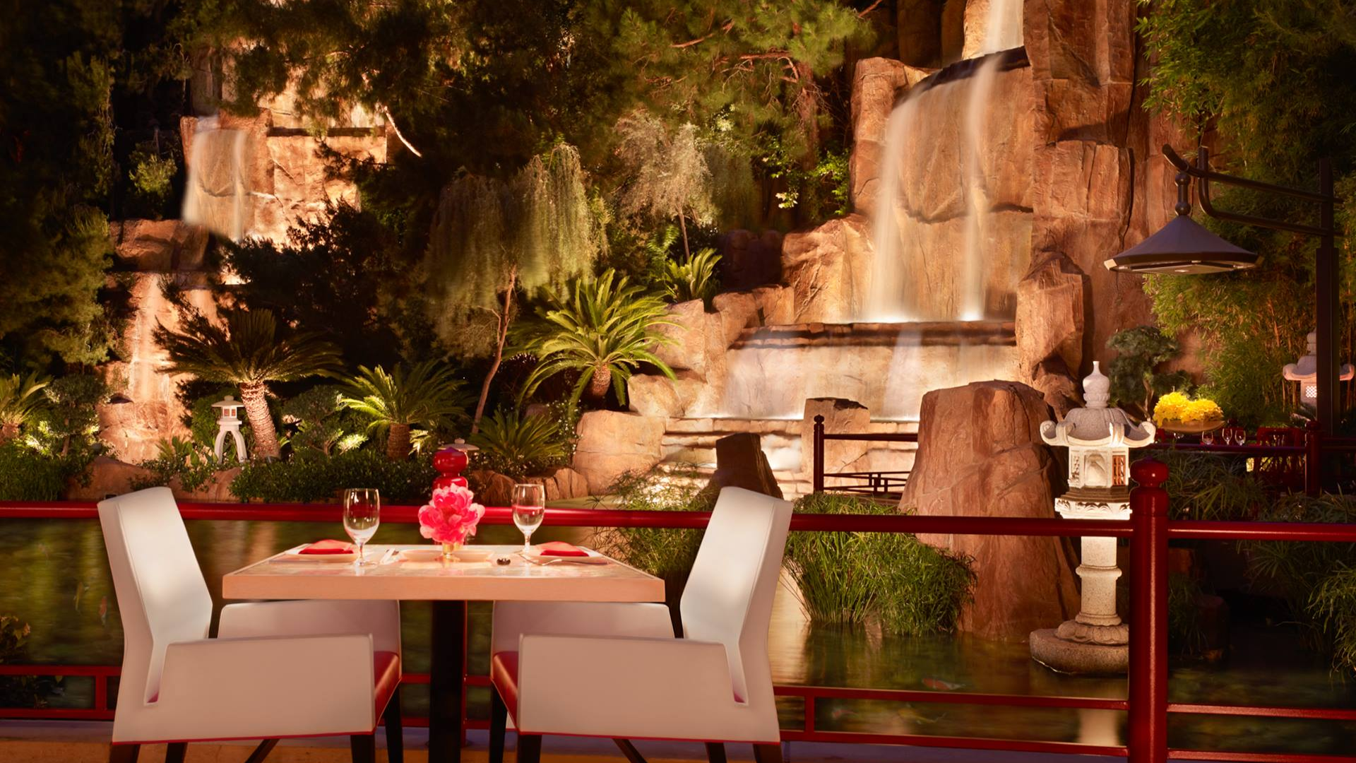 restaurant interior with dining table and chair and waterfall at the back