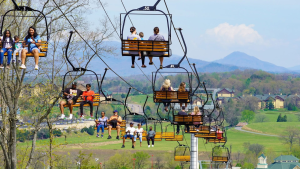 people riding up a tram with mountain views