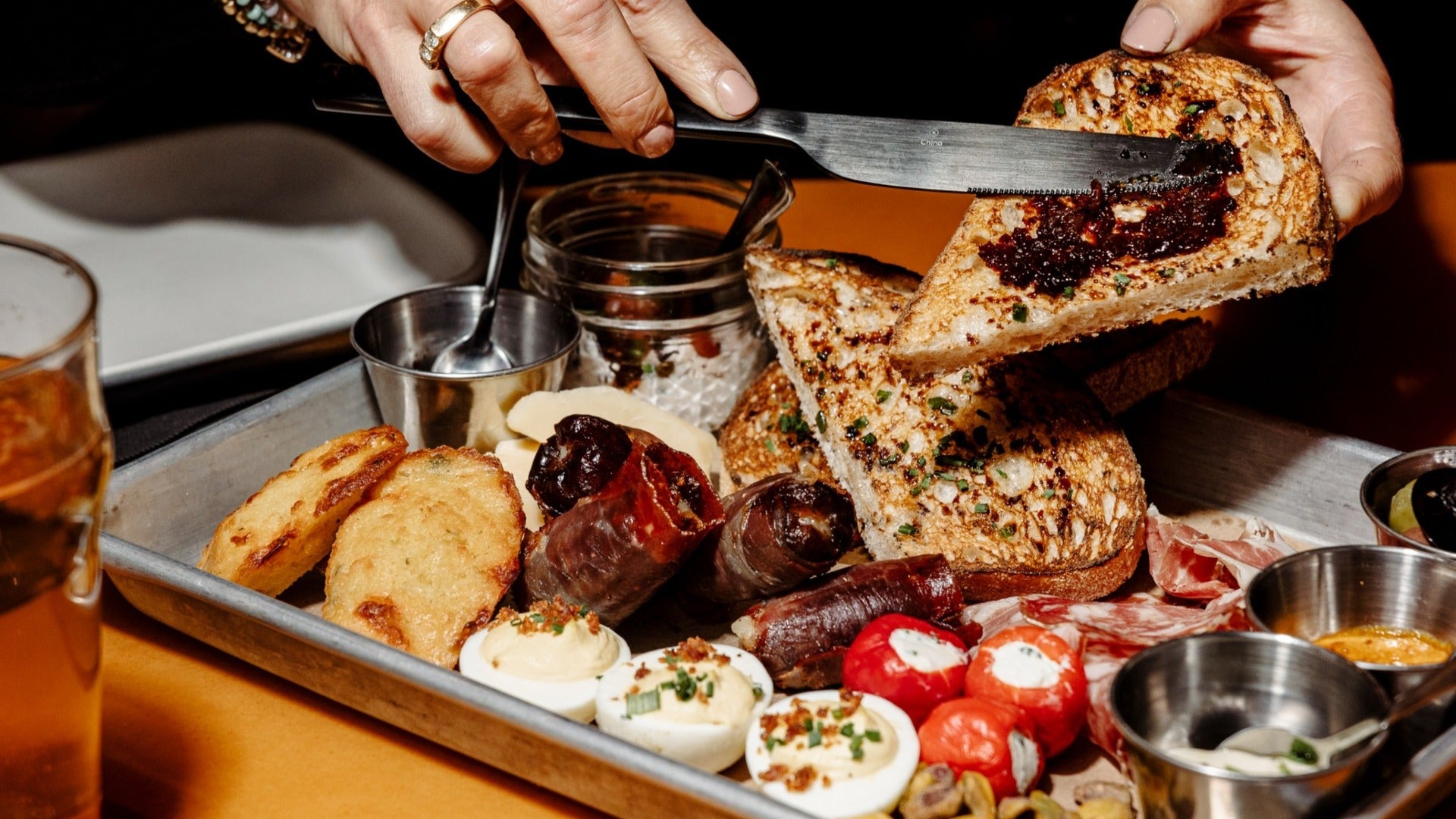 variety of spreads and starters on a tray