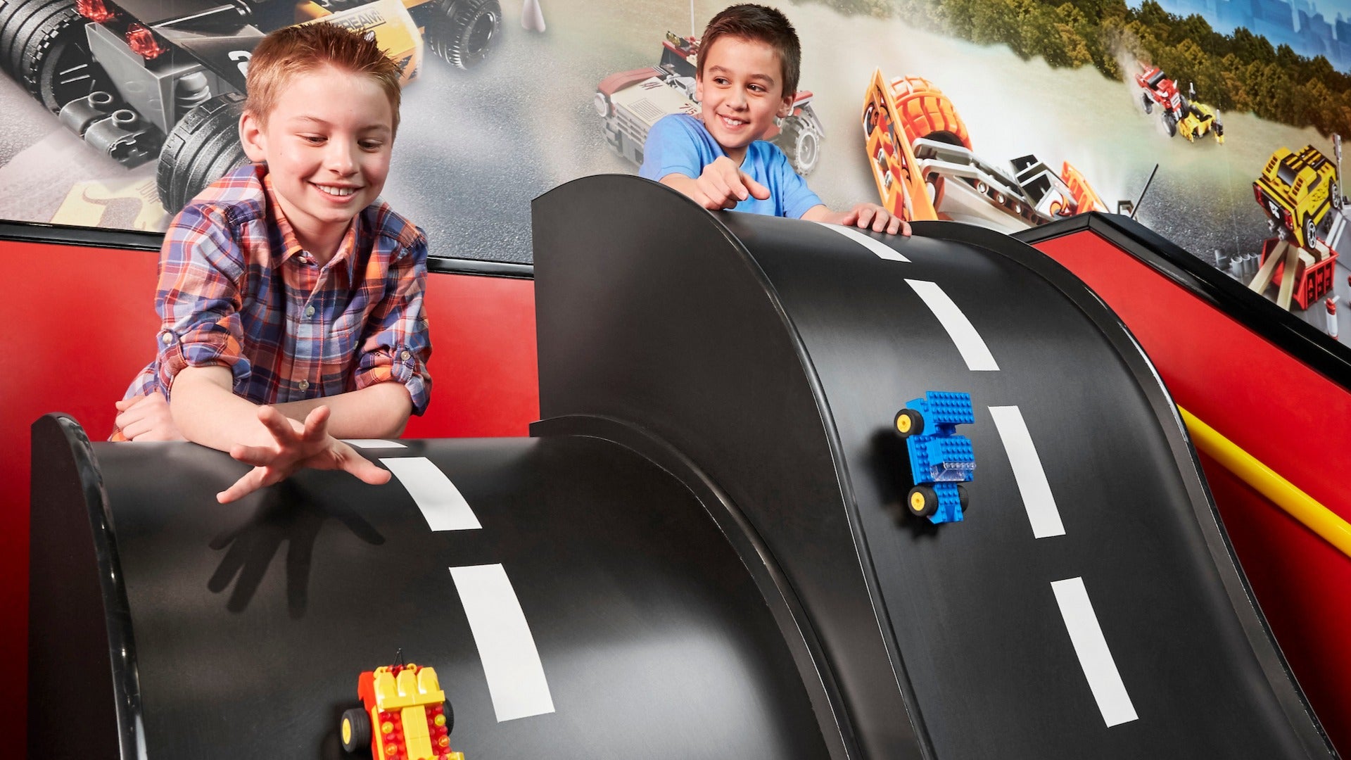 children playing with lego cars on a slide