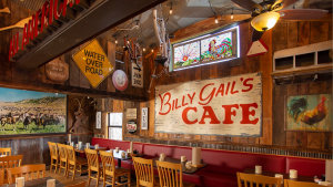 restaurant interior with signage, dining tables and chairs, rustic walls
