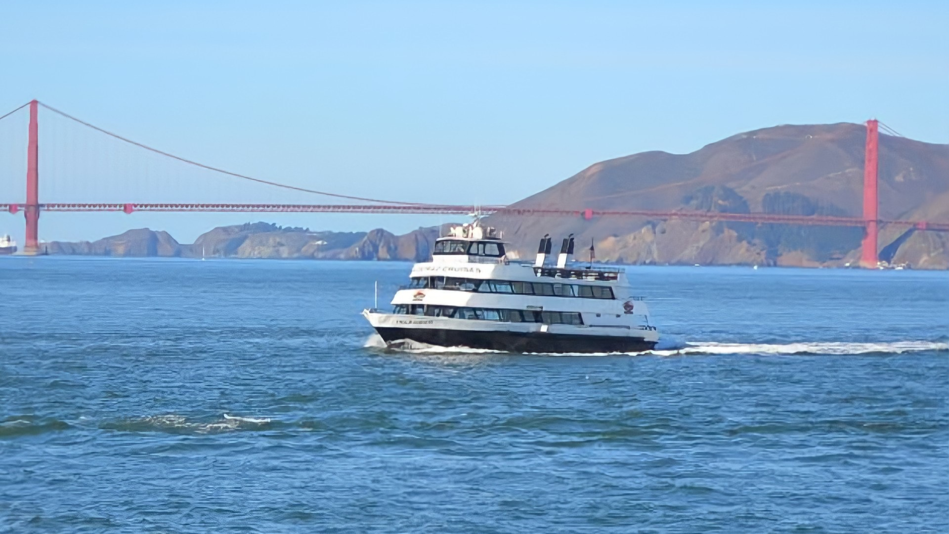 cruise boat with a view of golden gate bridge