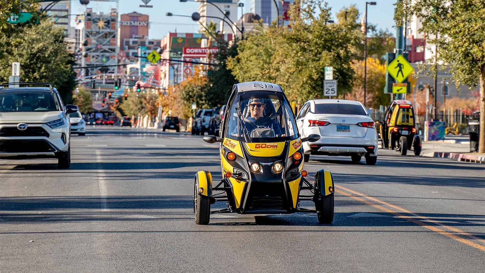 man in a gocar driving down the street