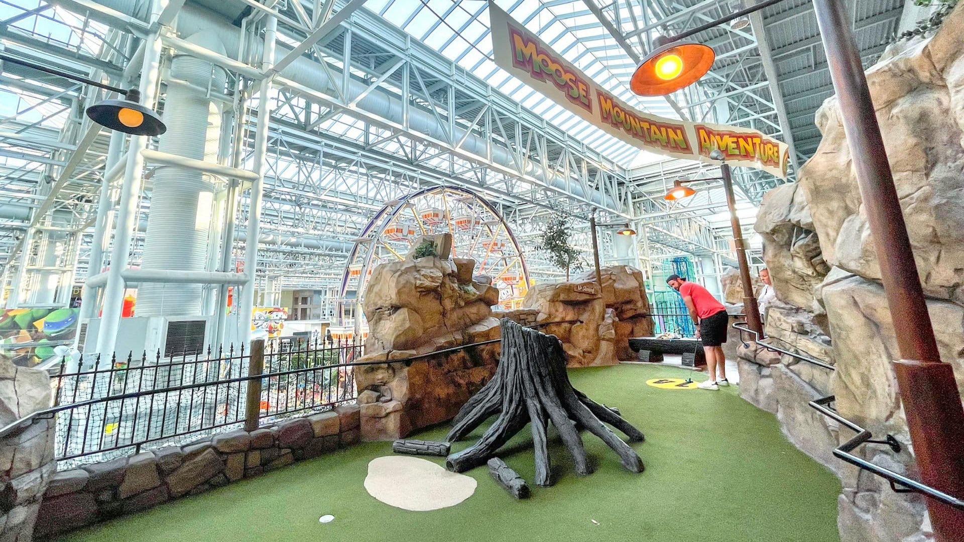 man playing mini golf in an indoor facility