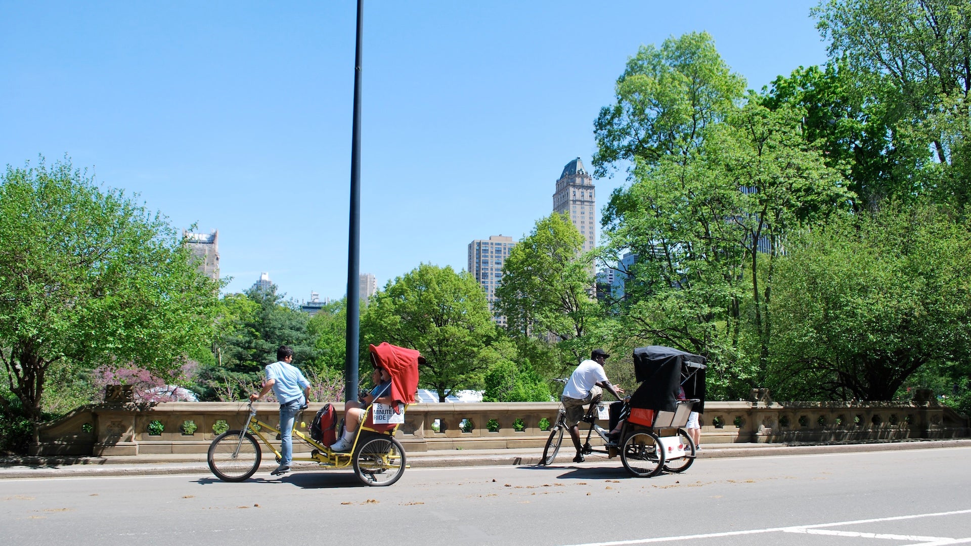 two pedicabs biking in opposite directions