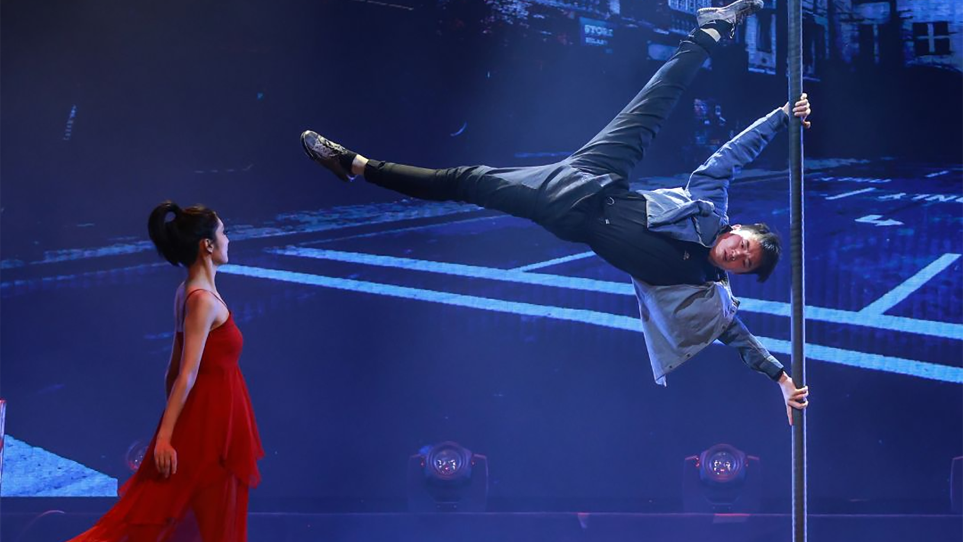 man on woman performing acrobats on stage