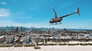 a helicopter flying above a city
