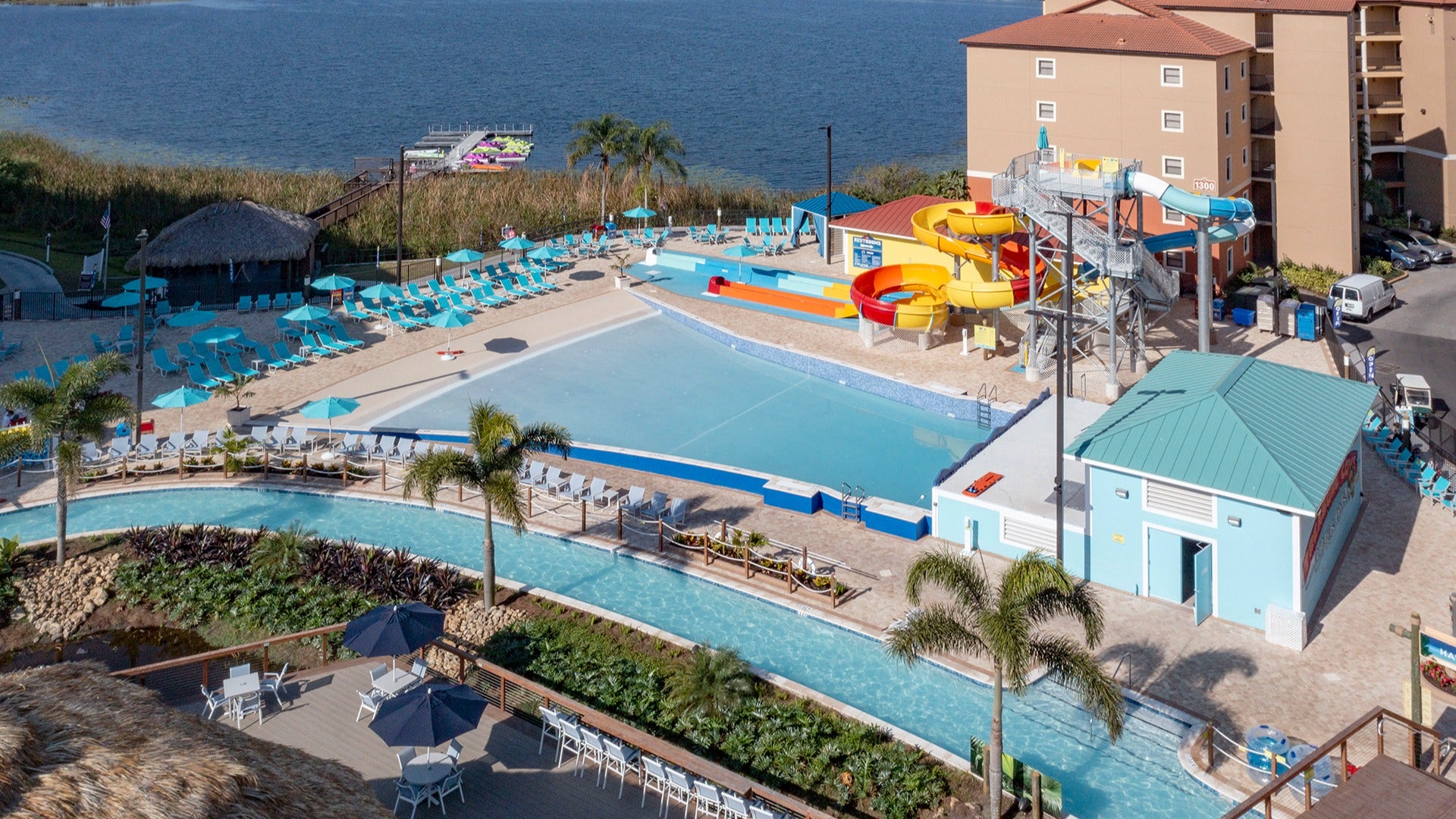 sprawling resort with water slides, lazy river, pool cabanas and chairs