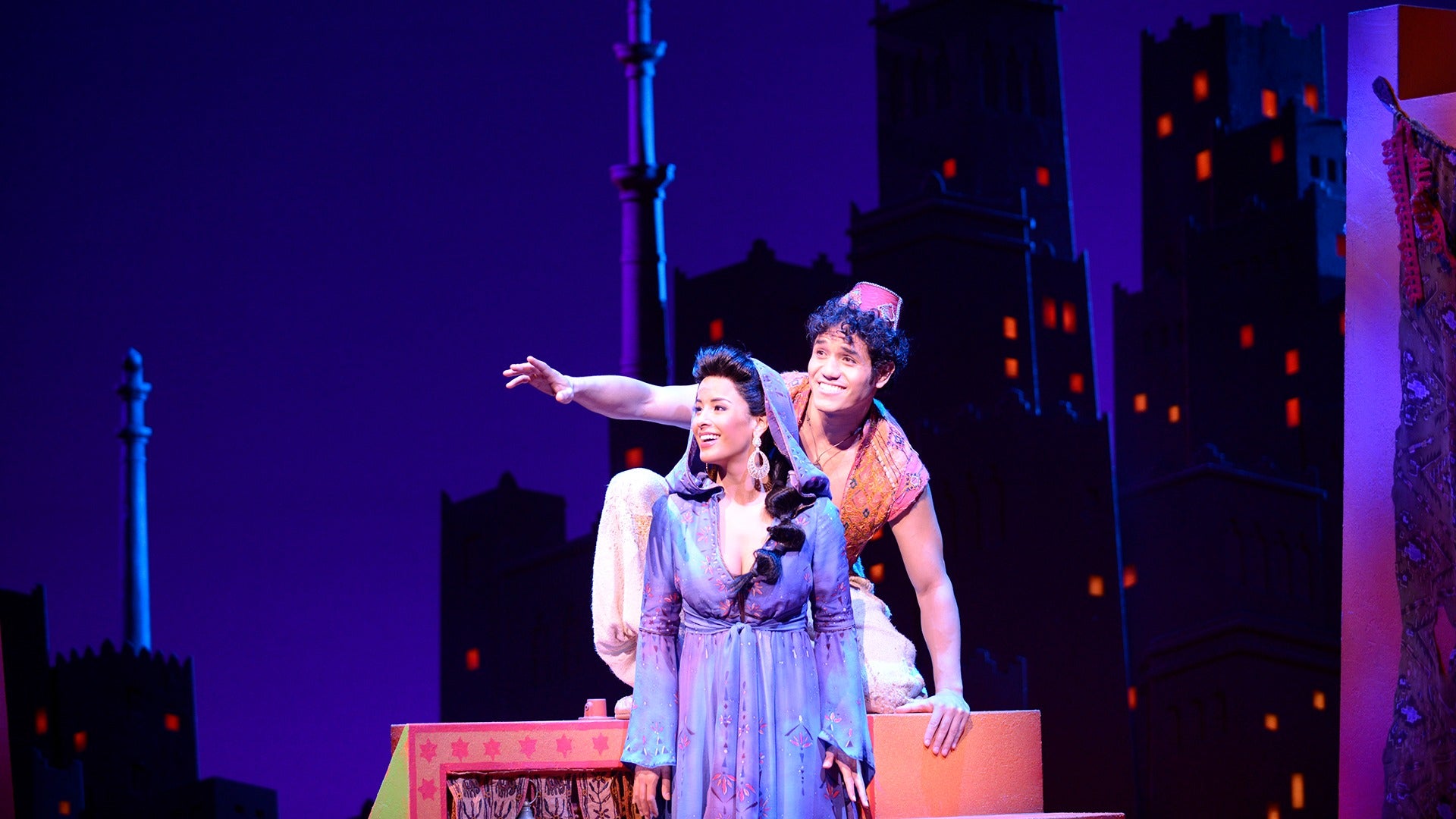 man and woman in costume on stage