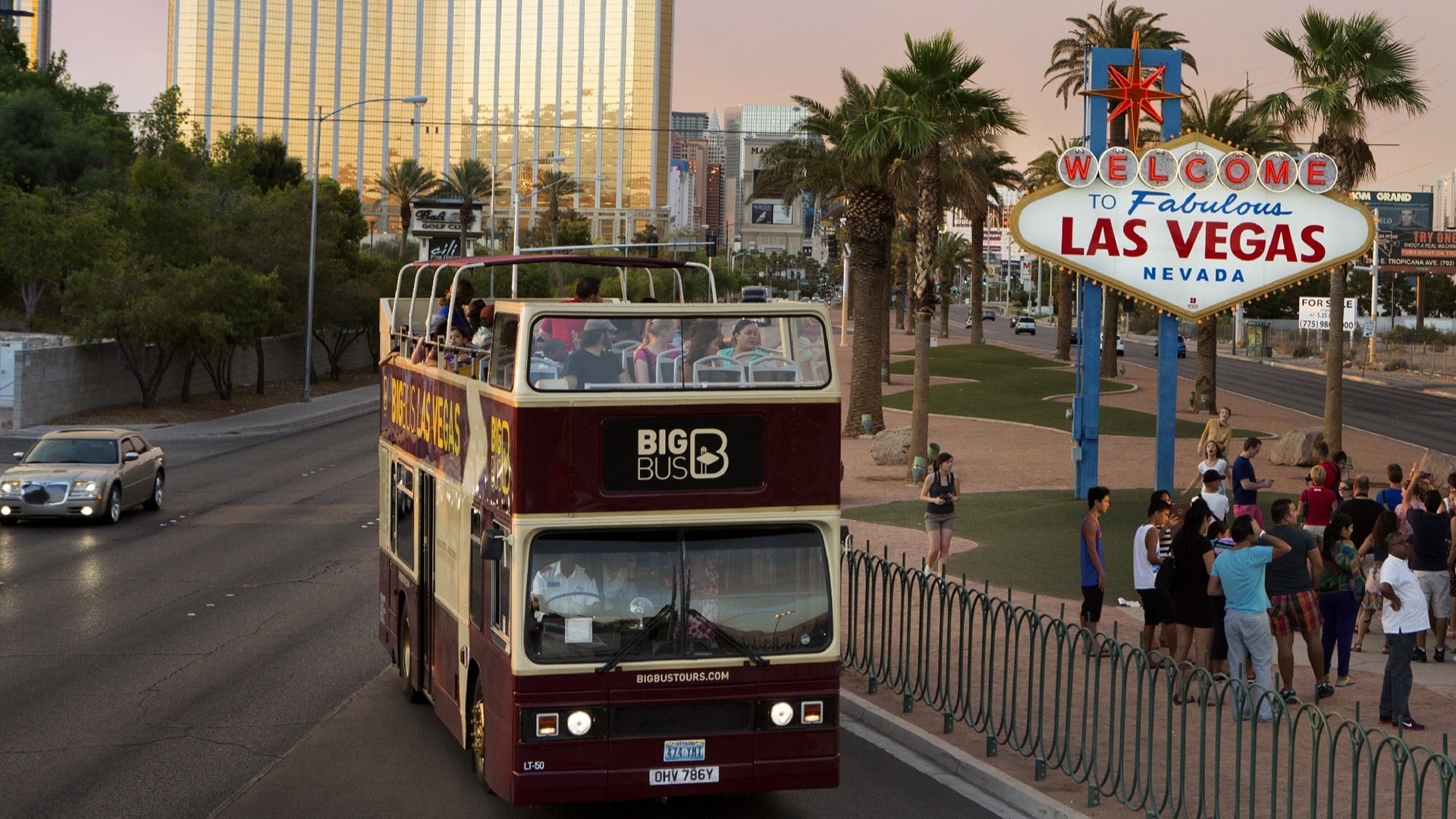 people on a tour bus with signage of las vegas on the side