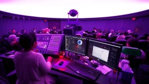 people in an observatory with an operator for the screen