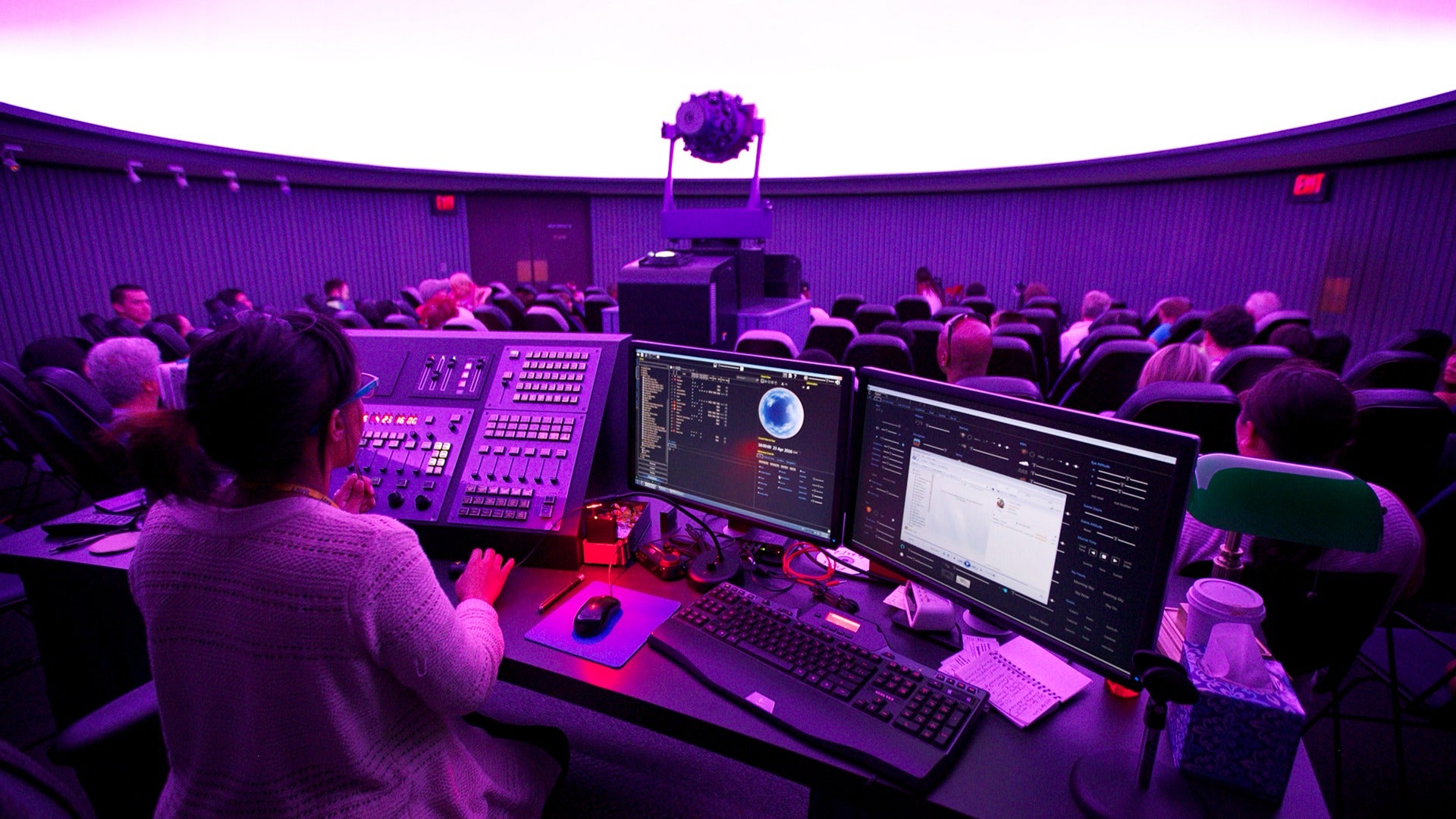 people in an observatory with an operator for the screen