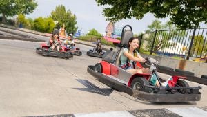 group of girl riding down go karts