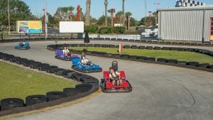 kids in go karts racing down a course