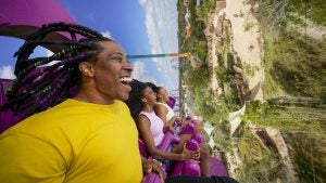 group of friends riding a roller coaster
