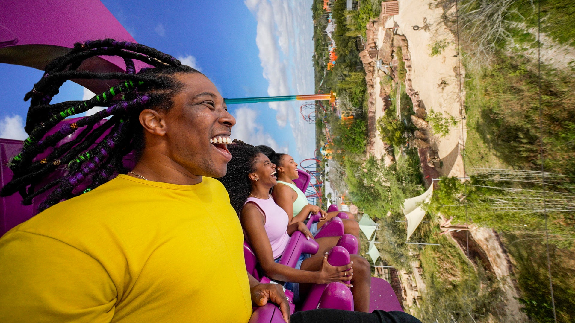 group of friends riding a roller coaster