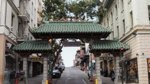 chinatown with dragon's gate and people walking around