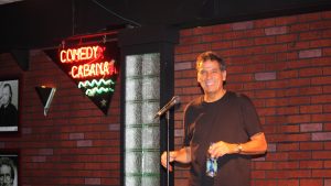 a man on stage holding a water bottle
