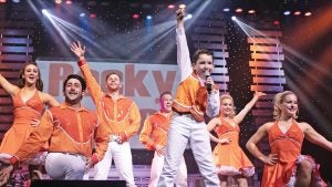 group of performers in costume on stage